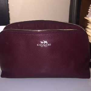 Maroon Coach makeup bag.